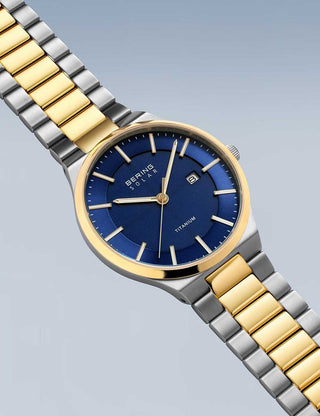 Angle shot of Bering 14439-717 Blue Dial Gold Titanium Unisex Watch on white background