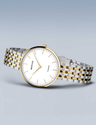 Angle shot of Bering 19334-010 White Dial Gold Titanium Womens Watch on white background