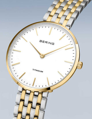 Angle shot of Bering 19334-010 White Dial Gold Titanium Womens Watch on white background