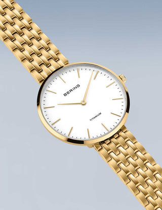 Angle shot of Bering 19334-334 White Dial Gold Titanium Womens Watch on white background