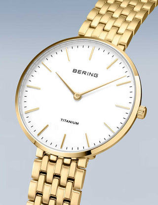 Angle shot of Bering 19334-334 White Dial Gold Titanium Womens Watch on white background