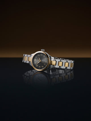 Angle shot of Victorinox 241841 Black Dial Gold Stainless Steel Womens Watch on white background