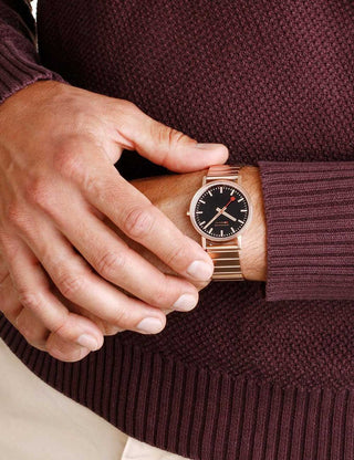 Angle shot of Mondaine A660.30314.16SBR Black Dial Rose Gold Stainless Steel Unisex Watch on white background