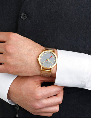Angle shot of Mondaine Classic Swiss Railways A660.30360.80SBM Grey Dial Gold Stainless Steel Unisex Watch on white background